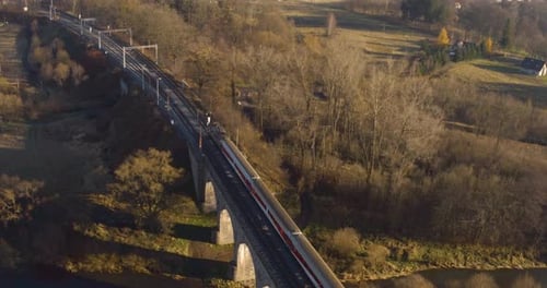 Scenic Aerial View of Train Crossing Stone Viaduct