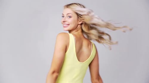 Smiling Woman Holding up Two Red Hearts