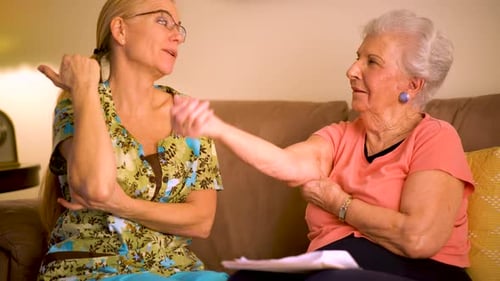 Caring Nurse Helping Senior Woman with Arm Exercises