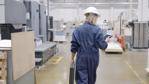 Female Factory Engineer with Toolkit Box Walking on Plant Floor