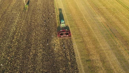 Tractor Plowing a Farm Field Aerial Shot