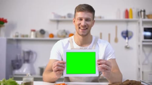 Cheerful Man Holding Tablet With Green Screen, Cooking Blogs and Apps Template