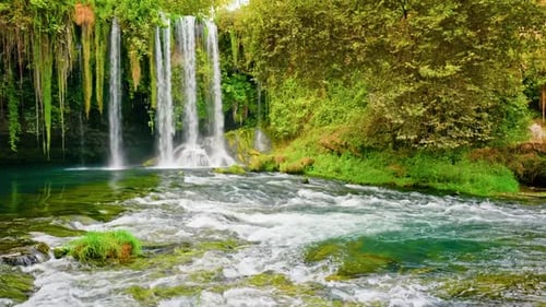 Lush Waterfall Flowing Through Green Tropical Nature
