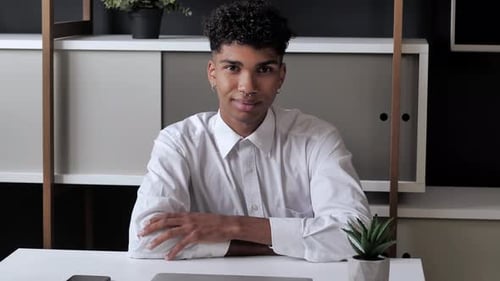 Smiling Young Adult at Modern Desk