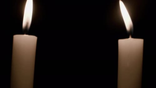 Glowing Candle Flames on Black Background