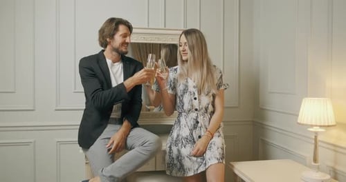 Elegant Couple Toasts with Champagne Indoors