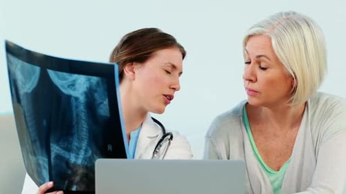 Doctor Consults with Patient Viewing X-Ray Results