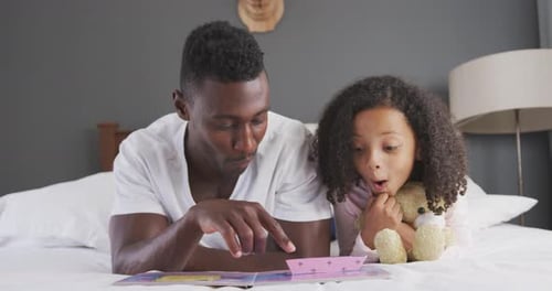Loving Father Reading Bedtime Story to Child