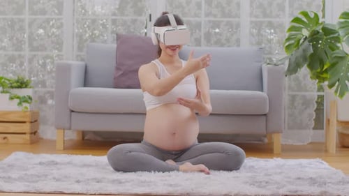 Pregnant Woman Using VR Headset in Her Living Room