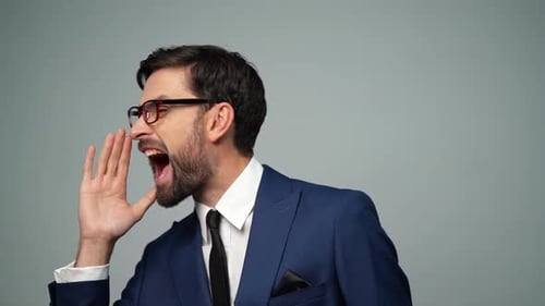 Man in Suit Shouting Loudly Wearing Glasses