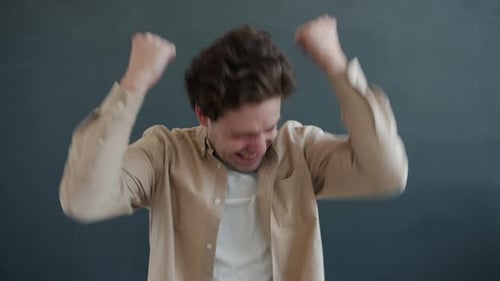 Man Cheers and Pumps Fists in Celebration