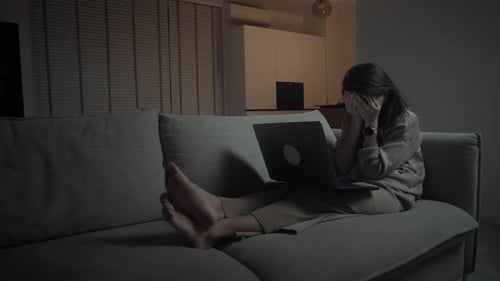 Woman Works on Laptop Late at Night