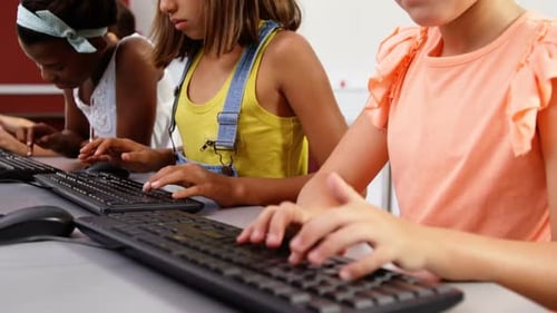 Children Typing on Keyboards in School Computer Lab