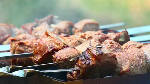 Juicy Meat Skewers Cooking over Grill