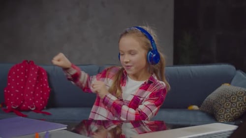 Carefree Cute Girl in Headphones Listening To Music