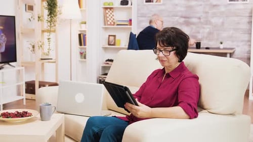 Woman Using Tablet in Sunny Living Room