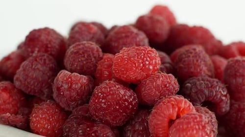Eco bright colorful berry raspberry rotates 360 on a white background. Close-up of loose raspberry