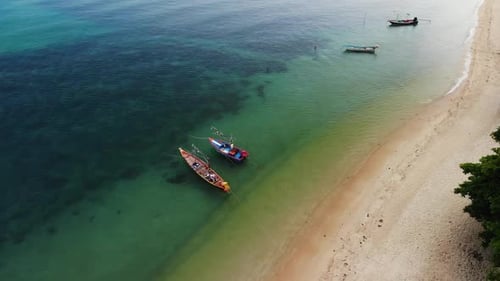 Fishing Boats Near Reef. Beautiful Aerial View of Fishing Boats Floating on Blue Sea Water