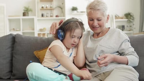 Grandmother and Granddaughter Listening to Music