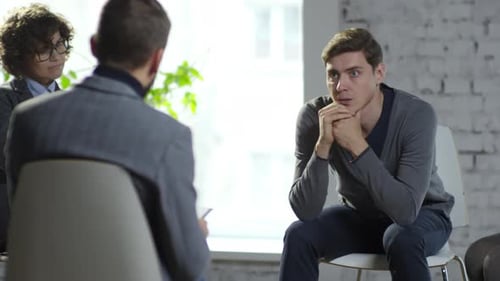 Intense Group Therapy Session with Man Speaking