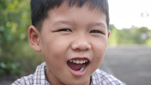 Close up little boy laughing and smile after hearing joke story
