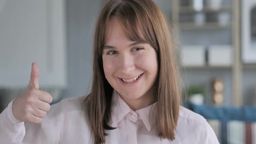 Woman Giving Thumbs Up and Smiling