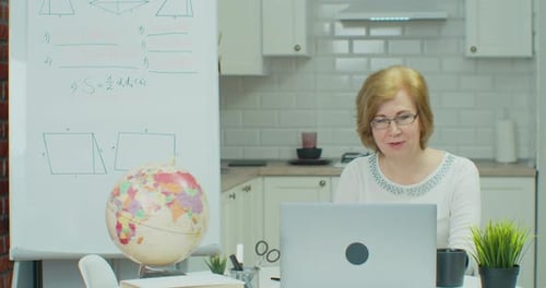 Adult Woman Teaching Online Math Lesson at Home