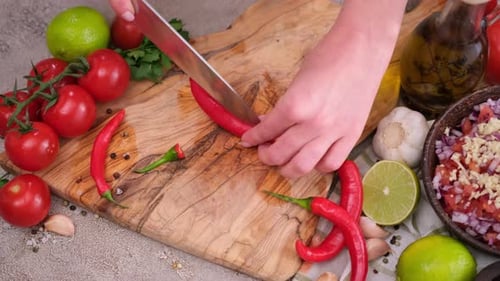 Preparing fresh salsa on wooden cutting board