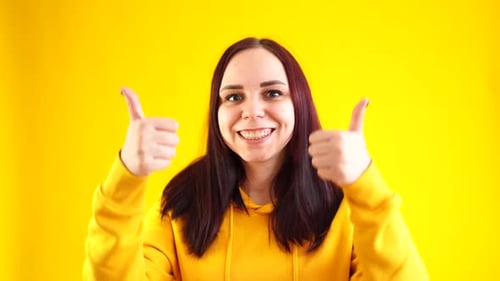 Happy Woman Gives Double Thumbs Up Gesture