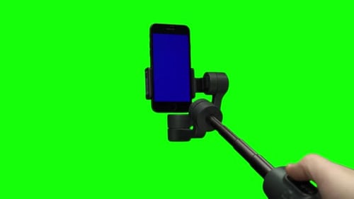Smartphone Mounted on Gimbal Stabilizer Over Green Screen