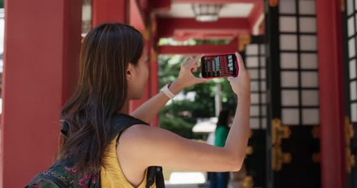 Woman Take Photo on Cellphone in Japanese Temple