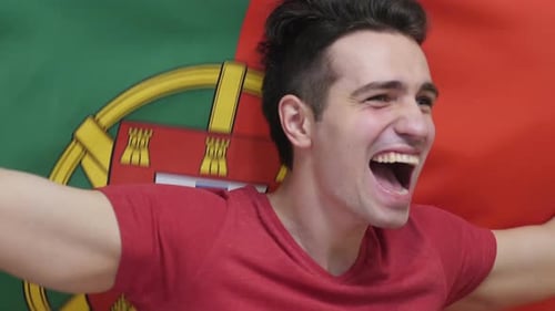 Young Adult Cheering with the Portugal Flag