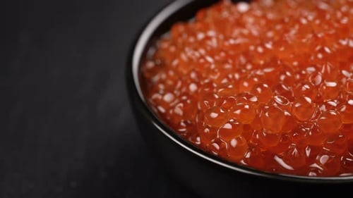Red Caviar Rotated Over Black Background