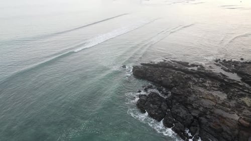 Aerial View of Waves Meeting Rocky Coastline