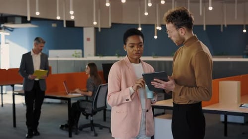 Male and Female Business Partners in Stylish Wear Standing Together at Business Center and