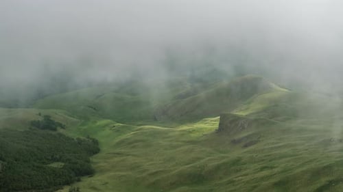 Mountain valley covered in fog clouds.