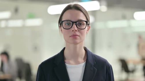 Professional Woman in Glasses Standing in Office