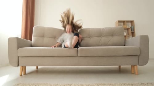 Happy Family Relaxing Together on Couch at Home