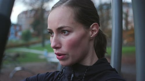 Beautiful Woman Using Gym Chest Press Equipment