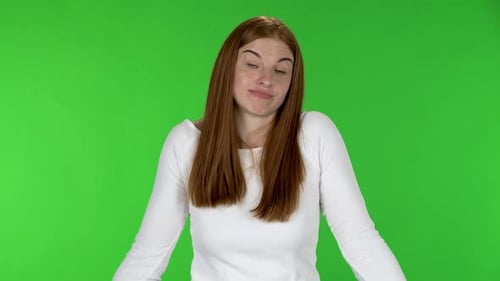 Woman Shrugs on Green Screen Backdrop
