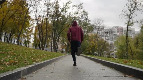 Slow Motion Jogger Running Outside in Autumn