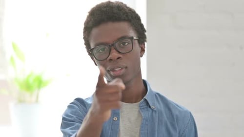 Young Adult Beckoning Forward with a Smile