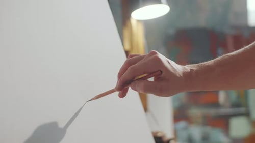 Hand of Male Artist Drawing with Pencil