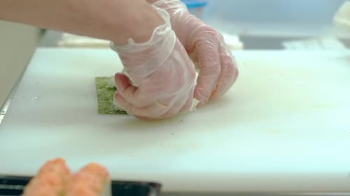 Sushi Chef Spreads Rice on Nori Sheet