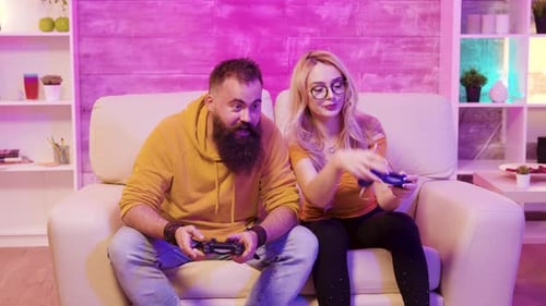 Couple Playing Video Games on Couch Together