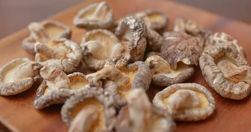 Dried Shiitake Mushrooms on Wooden Plate Close Up