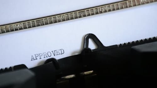 Typewriter Types the Word "APPROVED"