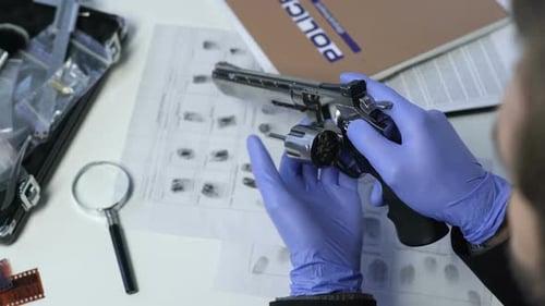 Police Officer Checking Revolver with Magnifier