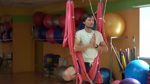 Young Adult Practicing Yoga in Aerial Hammock