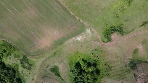 Scenic landscape shooting by drone. Aerial view of tourists track on the hill top. Natural beauty